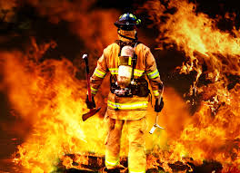 Photo of firefighter walking towards fire